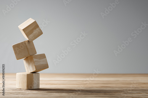 A pile of unstable wooden blocks symbolizes a structure or business building that is at risk.