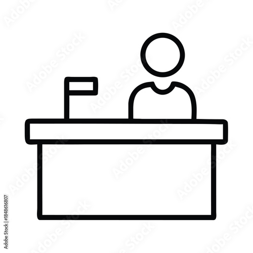 A person stands behind a reception desk with a small flag.
