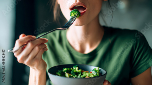 Radiant smile complements a vibrant salad, showcasing health and wellness through mindful nourishment.
