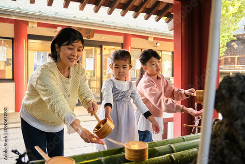 Japanese family enjoying temple purification ritual in Japan