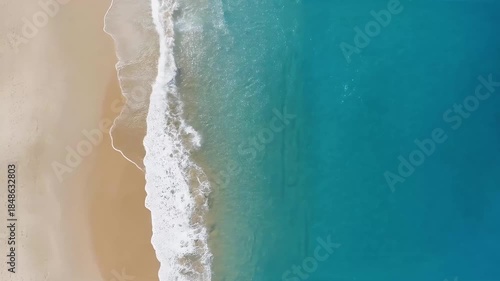 Aerial view of beach and ocean waves, Aerial view of a sandy beach meeting the ocean, with gentle waves lapping at the shore