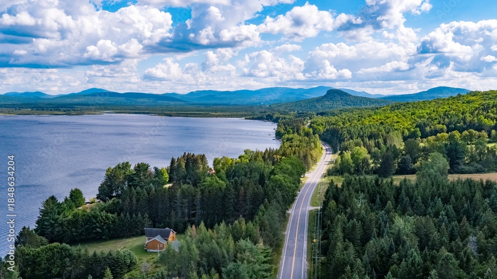 Obraz premium Aerial View of Scotch Cap, Quebec, Canada, and a Winding Road Through Forested Landscape Near a Lake