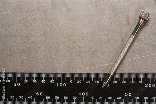 Tableau sur toile Metal scribe tool on scratched metal surface with steel ruler on industrial metal background