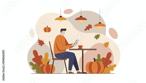 Man uses a tablet while drinking coffee in a cozy autumn cafe decorated with pumpkins and fall leaves