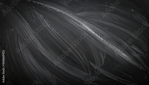 Abstract background featuring sweeping white chalk smudges across a dark, textured blackboard surface.