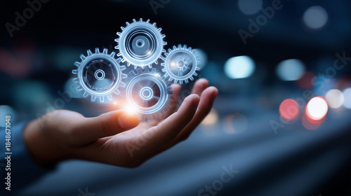 Faceless hand holding illuminated gears representing business technology and innovation concept, industrial digital transformation, mechanical intelligence, defocused technological