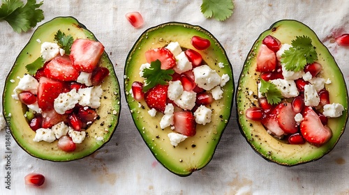 Avocado Halves with Strawberries, Feta Cheese, and Pomegranate Seeds on Light Background