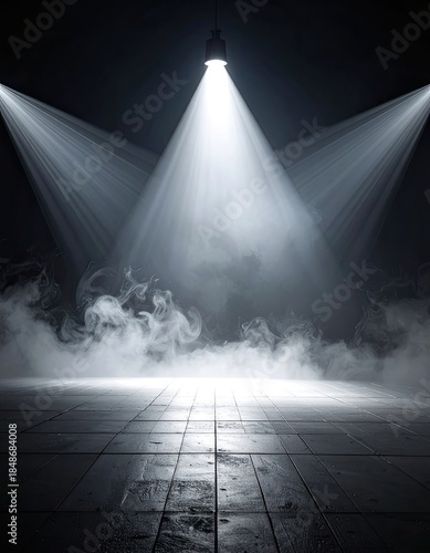 Dramatic stage lighting with fog illuminates a dark, tiled floor in an empty venue.