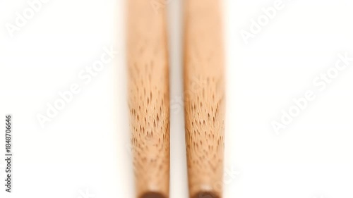 Close Up Of Two Wooden Chopsticks With Natural Grain Texture Isolated On White Background Studio Shot