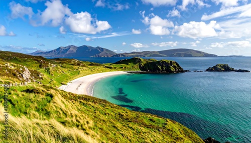 Beautiful coastal scene with green hills, a white beach, turquoise water, islands, and a blue sky with clouds