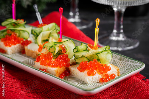 Christmas and New Year's dishes. Snacks and wine drinks for the holiday table. Canapes with red salmon caviar. Overhead