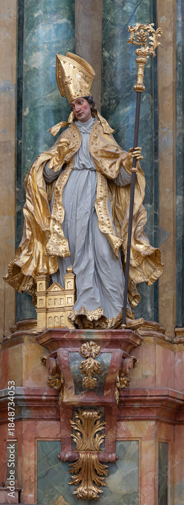 Fototapeta premium SALZBURG, AUSTIRA - SEPTEMBER 8 2025: The carved polychrome baroque statue of St. Augustine in the church Kollegienkirche by Simon Thaddäus Baldauf (1677–1753)