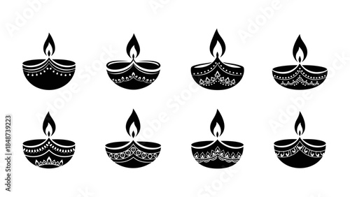 Collection of eight decorative black silhouette diyas for diwali festival celebration
