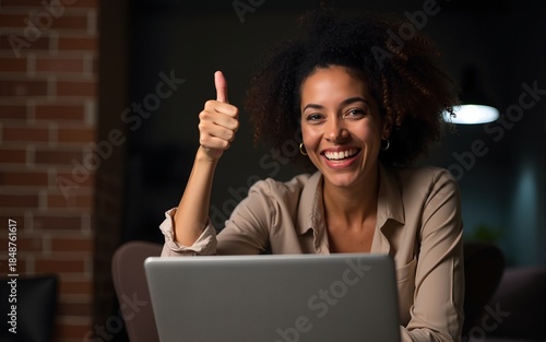 Middle age hispanic woman working using computer laptop at night approving doing positive gesture with hand, thumbs up smiling and happy for success. winner gesture. High quality