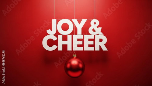 Joy and Cheer text with Christmas ornament festive holiday decoration for seasonal greetings and celebrations red background