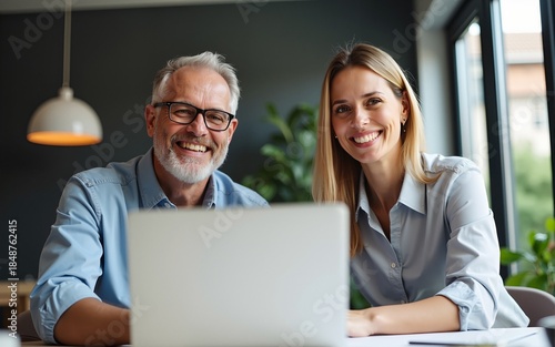 Two middle age business workers smiling happy and confident. Working together with smile on face using laptop at the office. High quality
