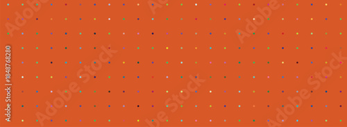 Vibrant array of small colored dots creating a rhythmic pattern on an orange surface for modern graphic design