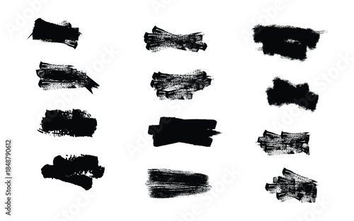 Collection of black smudge stamps and brush strokes on white background