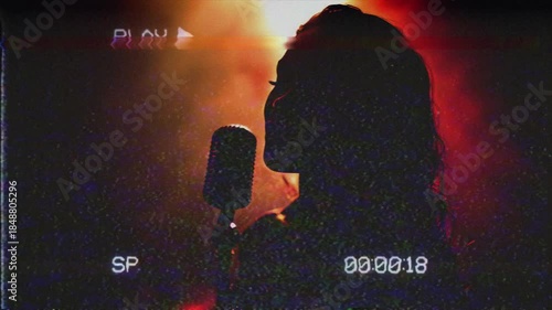 Silhouette of an African ethnicity woman singing to a microphone. VHS retro style music video
