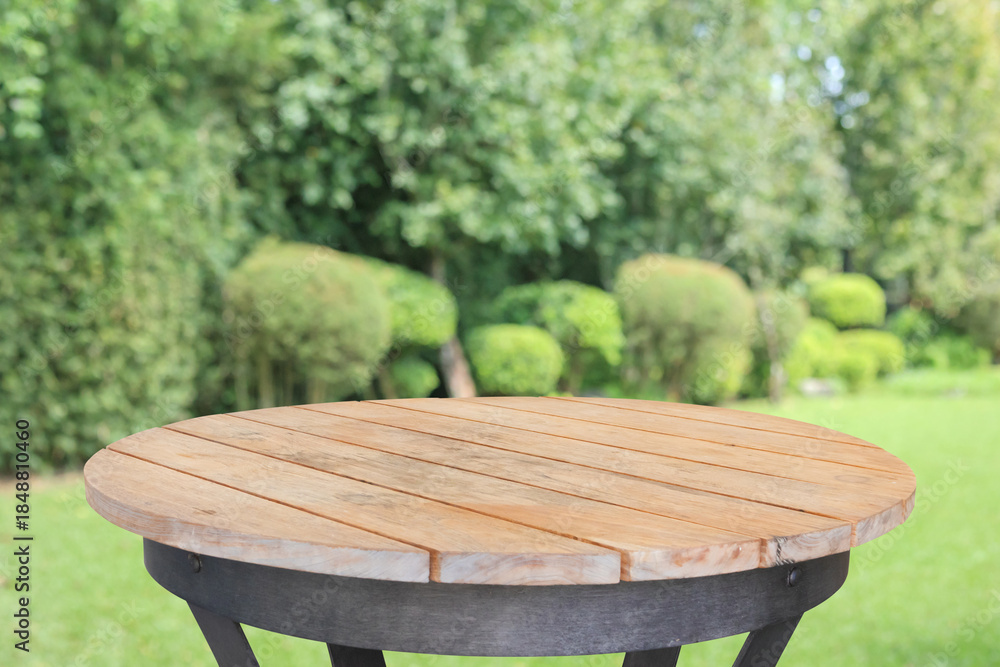 Fototapeta premium Empty round wood table top with abstract blur park garden background