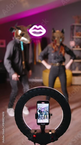 Teen creators in gold animal masks filming digital dance performance for halloween viral short video fan cam culture virtual idol creator economy trends