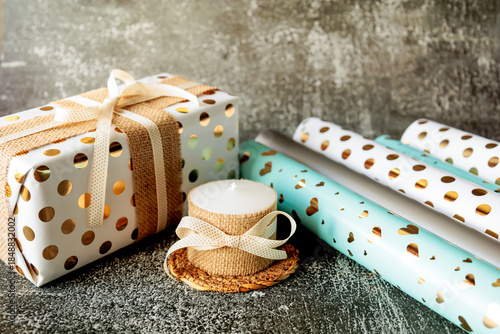 Wallpaper Mural Gift wrapped in festive paper and burlap ribbon next to a handmade candle. Cozy, rustic holiday mood with natural textures and golden accents. Perfect for Christmas or romantic occasions Torontodigital.ca