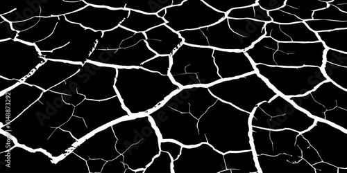 Abstract black and white cracked earth texture showing dry, fractured ground patterns. High-contrast natural surface background symbolizing drought, climate change, arid land, and environmental stress