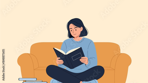 A young woman is reading a book while sitting cross-legged on a sofa, enjoying a quiet moment of relaxation and learning