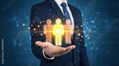 Businessman holding glowing digital people icons in hand. Concept of human resources, team, and network technology