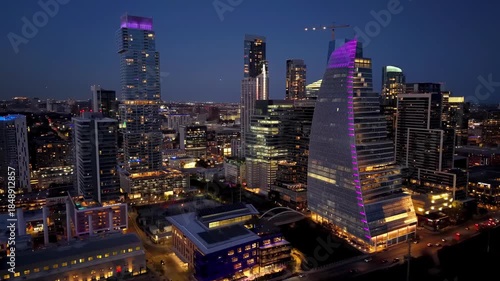 Nightscape of Austin's downtown with glowing skyscrapers, city lights, and river reflections. Urban and cityscape concepts
