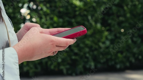 Close-up of a hands using mobile app, business communication during walking. High quality 4k footage