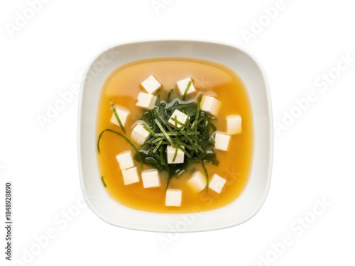 Isolated square bowl of traditional Japanese miso soup with tofu, seaweed, and broth
