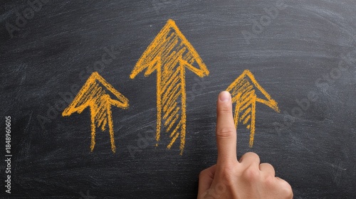 Three yellow arrows drawn on chalkboard pointing upwards concept