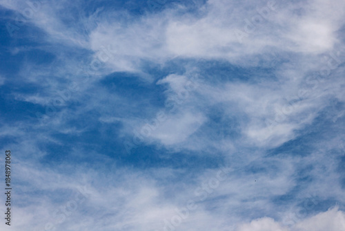 Wispy White Clouds in a Blue Sky. Blue Cloudy Sky. Nature and Climate Concept. Realistic Cloudscape. High quality photo