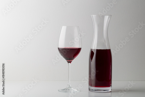 Red wine glass and bootle with shadow on withe background