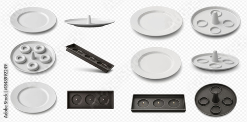 Set of various white and black ceramic fondue plates and trays with compartments for sauces and food.
