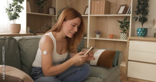 Smiling Woman with CGM Sensor and Smartphone Managing Diabetes at Home
