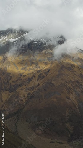 Clouds Rolling Over Sunlit Andean Peaks