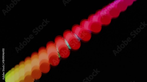 Colorful light patterns form circular shapes and waves during an event at night in the city