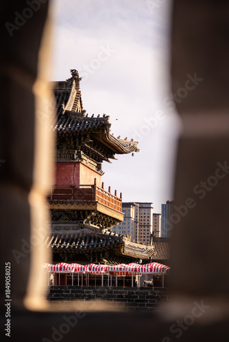 Ancient Chinese Pavilion Framed Through Stone Wall