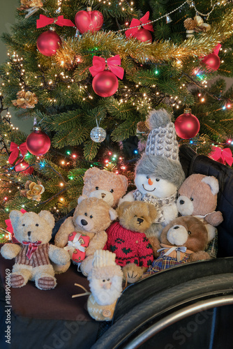 a large group of children's toys under a Christmas tree in a wheelchair