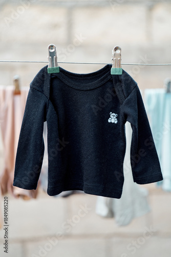 Baby sweater hanging on a clothesline