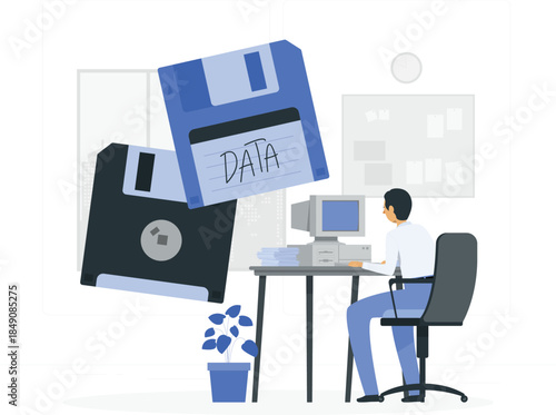 Man sitting at desk with computer and large floppy disks data desi
