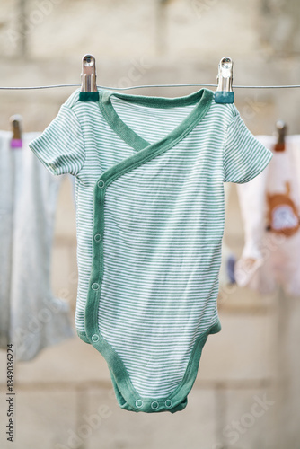 Striped baby bodysuit hanging