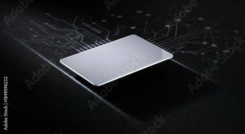 Sleek metallic silver card floating above a dark surface with glowing digital circuit board patterns.