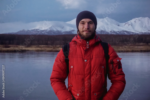 A Man on a Frozen Lake with a View of Kamchatka Volcanoes