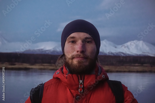 A Man on a Frozen Lake with a View of Kamchatka Volcanoes