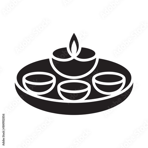 A simple black and white illustration of a traditional diya and sweets platter