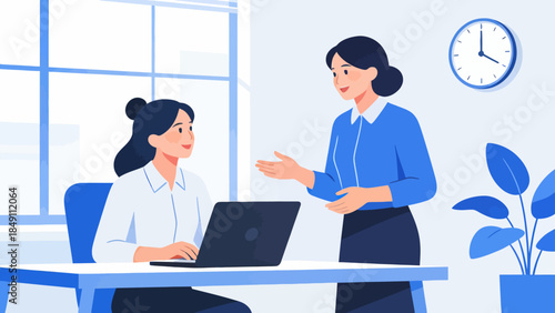 Office workers collaborating on laptop