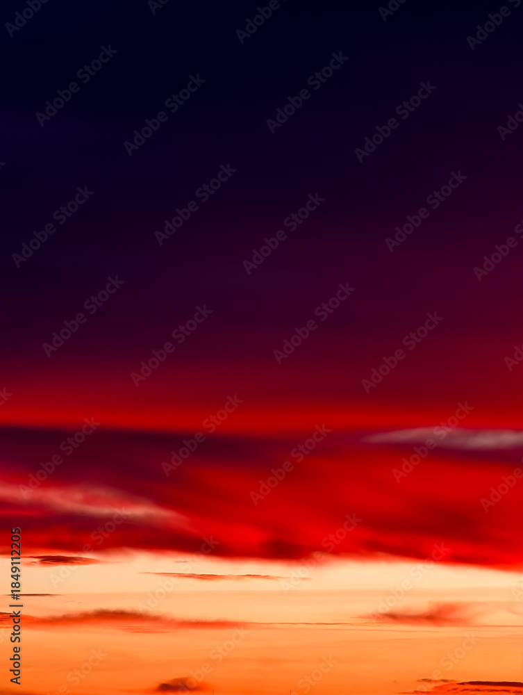 Fototapeta premium Sunset sky with dramatic streaked clouds and vibrant red-orange-purple hues – ideal nature background for commercial use Abstract Gradient Backdrop